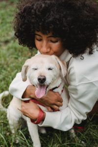 woman kissing dog